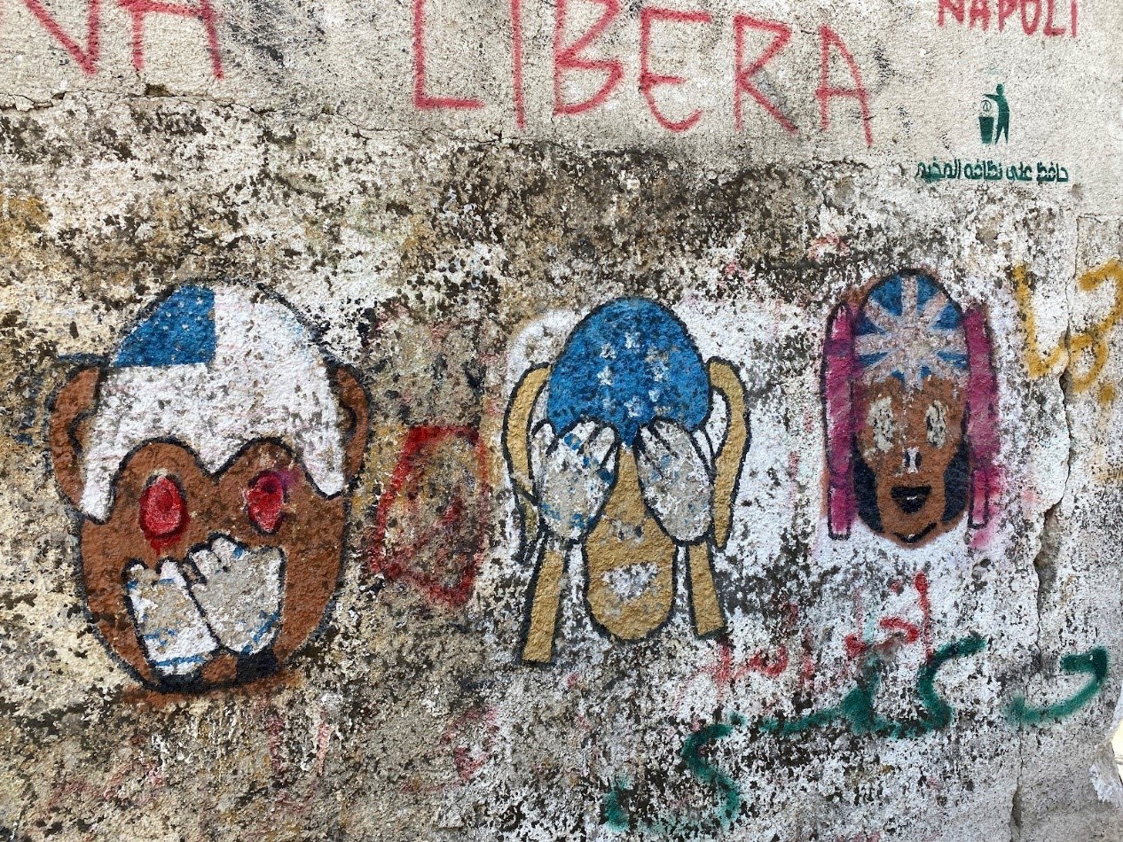Caption: Monkeys representing the United States, the United Nations, and Great Britain are graffitied on the partition wall on the edge of Aida Camp. The image serves as a critique of how the governments have failed to support and protect Palestinian refugees from Israeli forces.